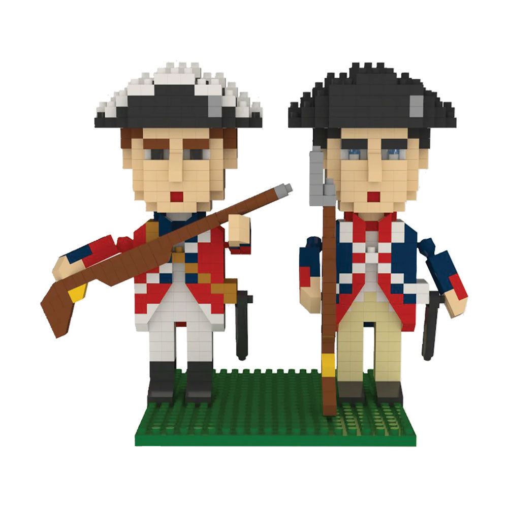 Two soldier figures from the Revolutionary War Soldiers Mini Blocks set stand on a green baseplate, dressed in 18th-century uniforms—one in a red coat with a rifle, the other in blue with a staff.
