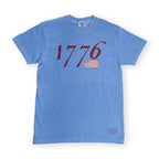 Show your love for American history with the We Hold These Truths 1776 T-Shirt in washed denim, featuring “1776” in bold red font and an early American flag graphic centered on the chest—a classic choice for celebrating July 4th or embracing timeless patriotic style.