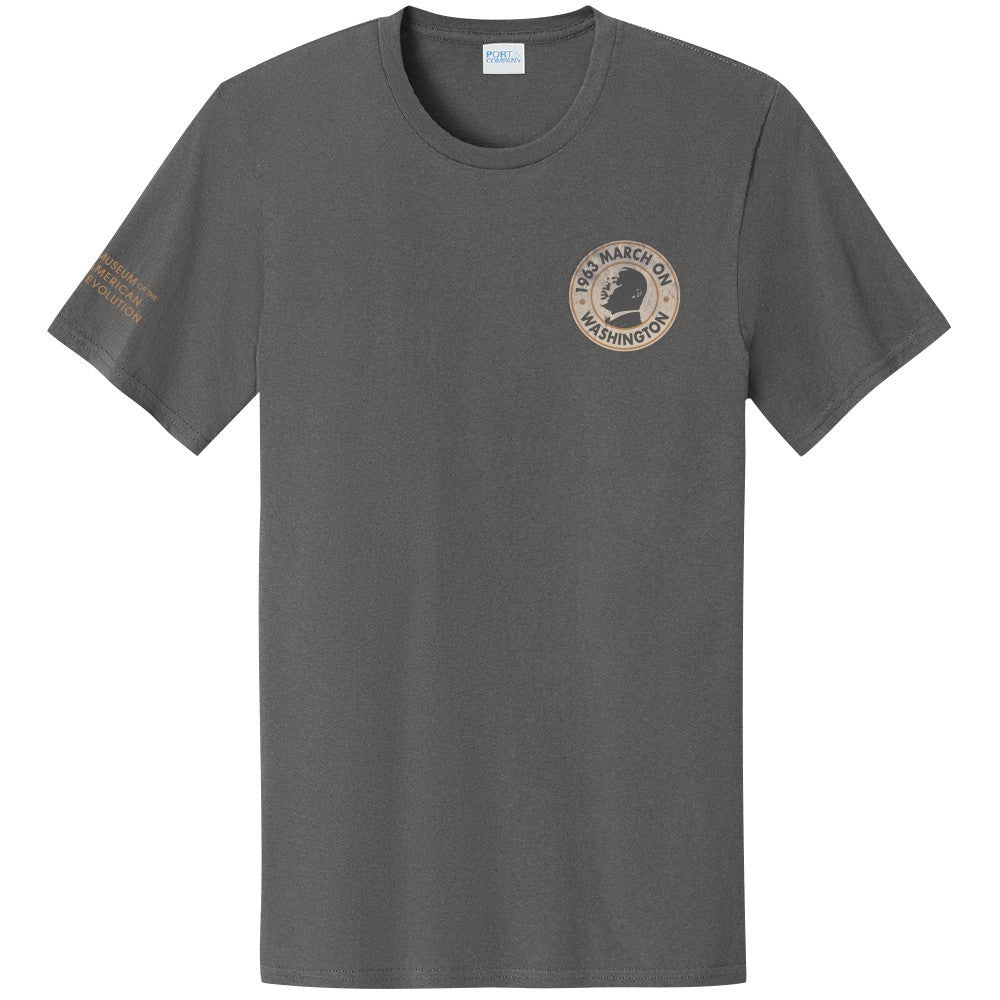 March on Washington T-Shirt in gray with a small beige circular logo — peace sign and "1963 March on Washington" — on the left chest, plus a beige inscription on the left sleeve.