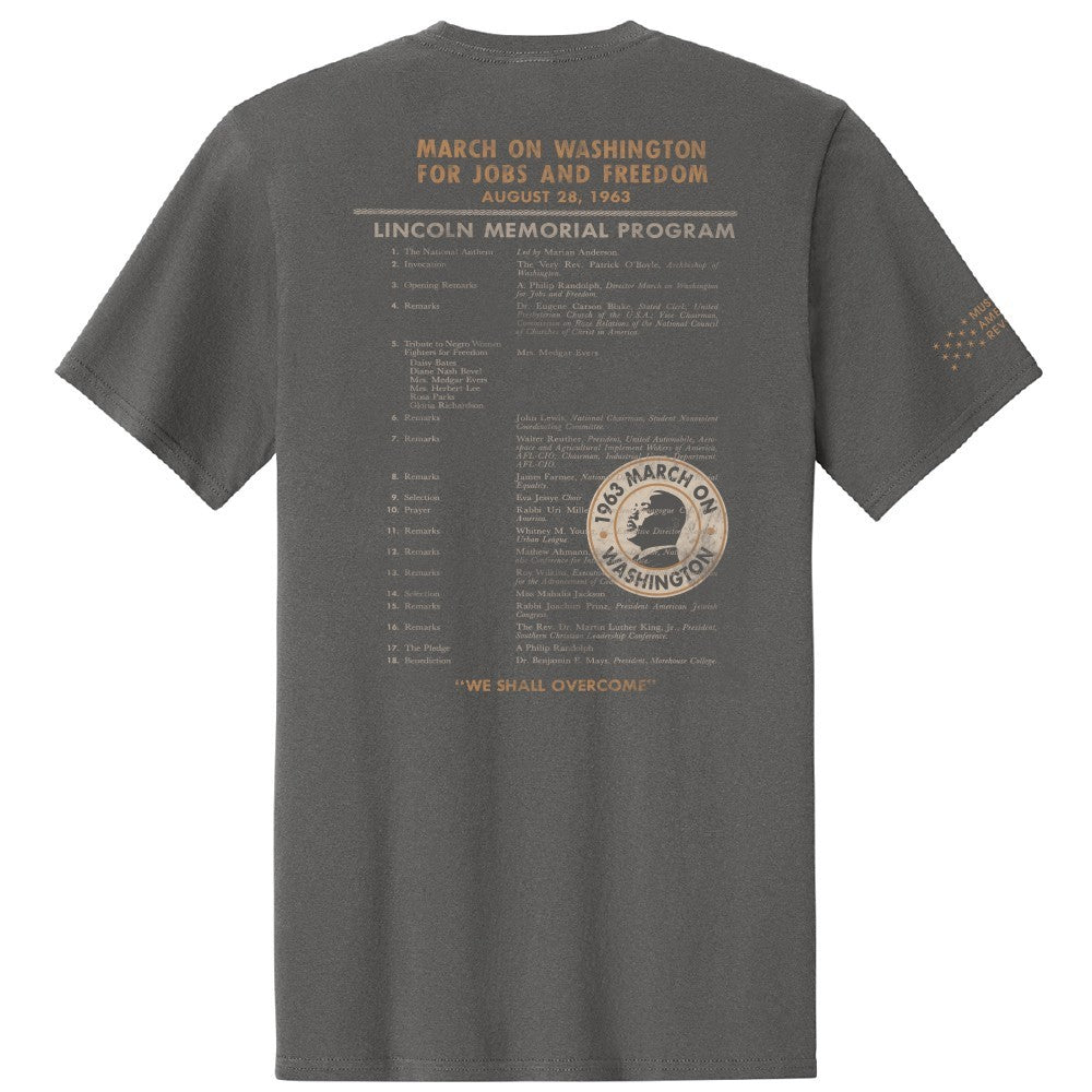 March on Washington T-Shirt in gray features the 1963 “Lincoln Memorial Program,” “We Shall Overcome,” tan lettering with civil rights event details, and a circular march logo.