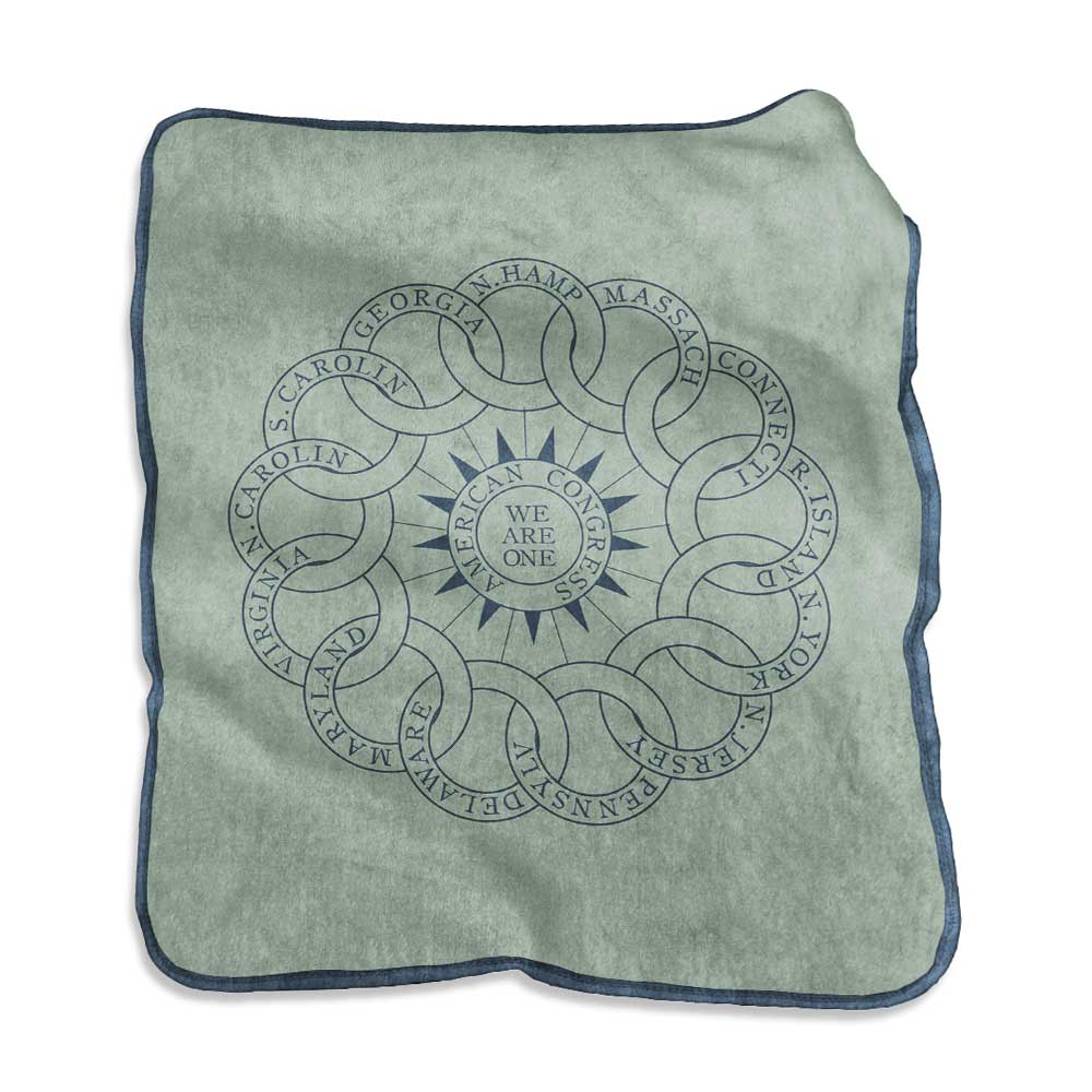 The Chain of States Blanket is a soft, light green fleece with interlocking rings representing the original U.S. colonies circling “WE ARE ONE”—a tribute to American history and unity.