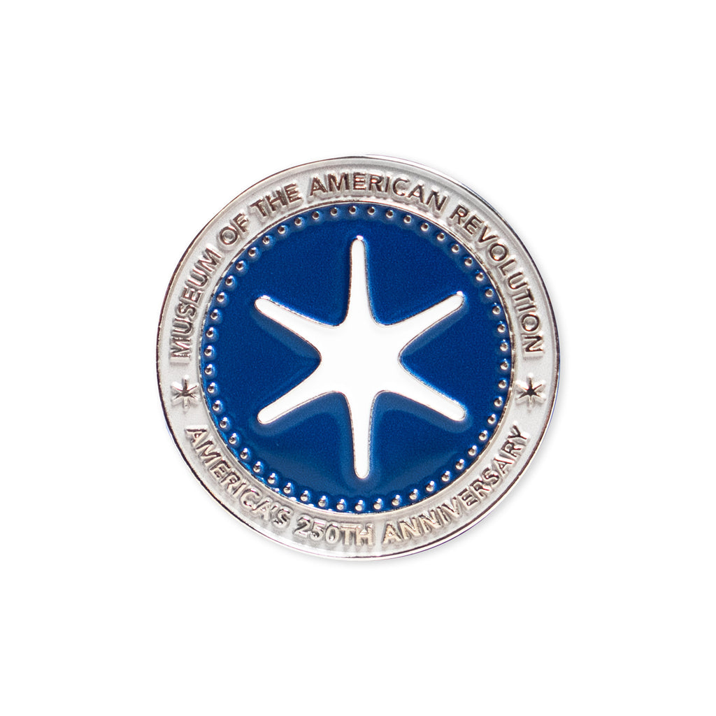 A round silver and blue Challenge Coin featuring a six-pointed white star at the center and a border that reads "Museum of the American Revolution" and "America's 250th Anniversary.
