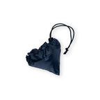The Celebrating 250 Packable Tote Bag, a dark blue triangular satin pouch with a black drawstring closure, is cinched at the top and rests on a white background.
