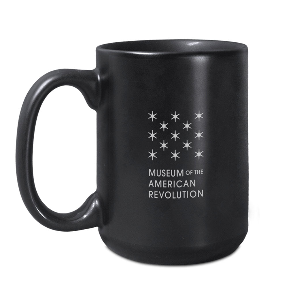 The Join or Die Mug is a black ceramic mug with white stars and "Museum of the American Revolution" text. It has a large handle and matte finish.
