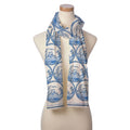 The Blue Crab Scarf, featuring blue circular oriental landscape patterns inspired by the Chesapeake Bay, is draped around the neck of a beige mannequin torso.