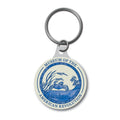 A round keychain with a blue and white design featuring the text Museum of the American Revolution and an illustration of a blue crab.