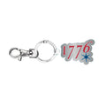 The 1776 Keychain features a lobster clasp, circular key ring, and a charm with "1776" in red numbers and a blue star under the last digit.