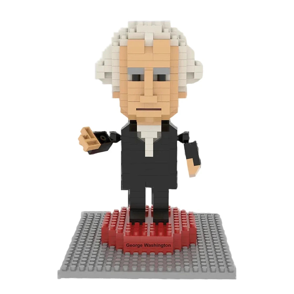 The George Washington Mini Blocks set features a LEGO-style figure with white hair and a black suit on a gray and red baseplate with a nameplate. With 323 pieces, it's perfect for collectors. The background is white.