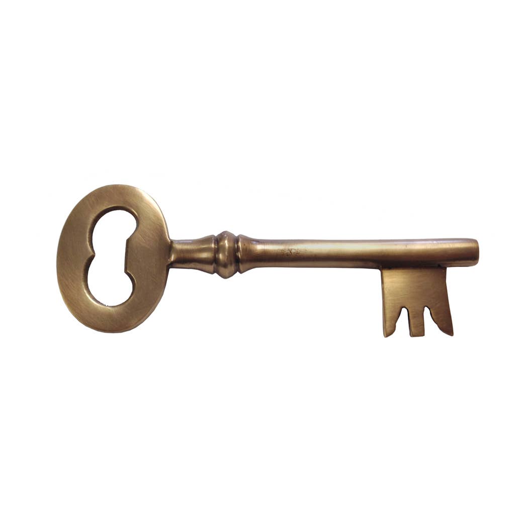 The Antiqued Brass Key Bottle Opener features a vintage design with an ornate round bow and notched bit, crafted to resemble an old brass skeleton key. Shown on a white background.