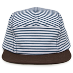 The Strped Camper Hat, Baby/Toddler is a stylish kids’ hat made from blue and white striped cotton, featuring a flat, dark brown brim. Shown from the front against a white background, this camper hat includes an adjustable snapback for a comfortable fit.