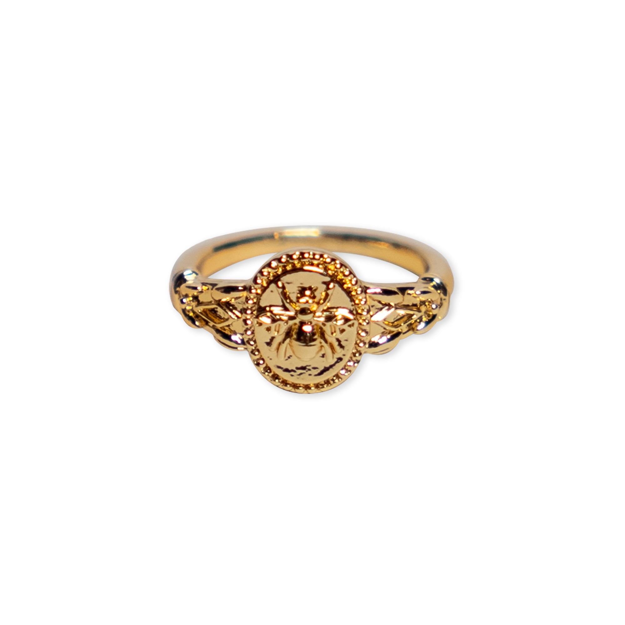 Gold Bee Ring: A gold-plated brass ring showcasing an oval-shaped centerpiece engraved with a bee design, flanked by delicate decorative accents on both sides—perfect as a unique stacking ring.