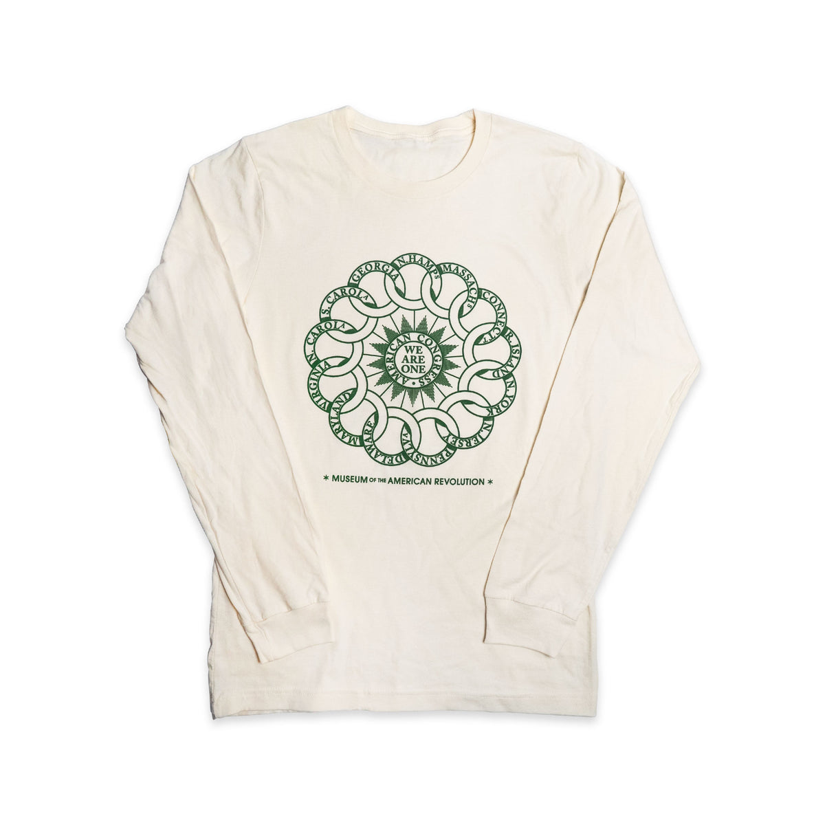 The Chain of States Long Sleeve Shirt is a cream-colored, long-sleeve shirt made from 100% organic cotton. It features a green circular interlocking rings design with the words “We Are One” at the center and “Museum of the American Revolution” below, symbolizing American unity.
