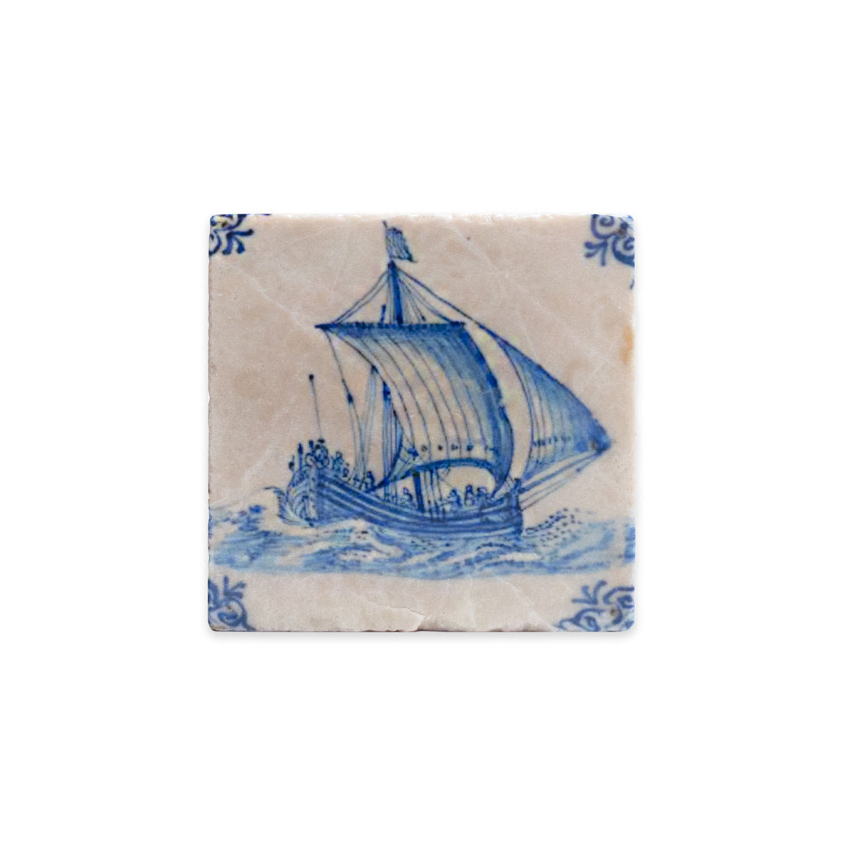 Delft Boat Stone Coaster, a square marble drink coaster featuring a blue and white illustration of a sailing ship on water with decorative corner patterns in the style of an antique Delft tile.