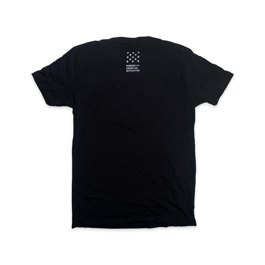 The Created Equal T-Shirt is shown laid flat, back side up, featuring small white text and a pattern of stars near the top center. This patriotic t-shirt subtly nods to American heritage and is displayed against a plain white background.