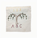 The Embroidery Kit features a square fabric with hand-stitched tree, 1 2 3 above, and A B C below—ideal for beginners or anyone interested in exploring hand-stitched designs.