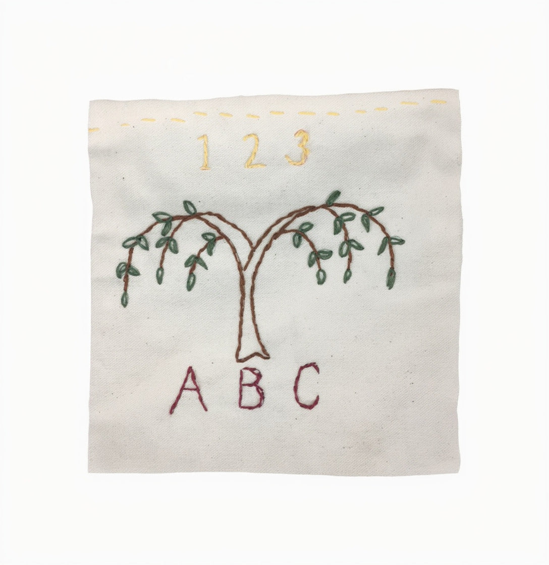 The Embroidery Kit features a square fabric with hand-stitched tree, 1 2 3 above, and A B C below—ideal for beginners or anyone interested in exploring hand-stitched designs.