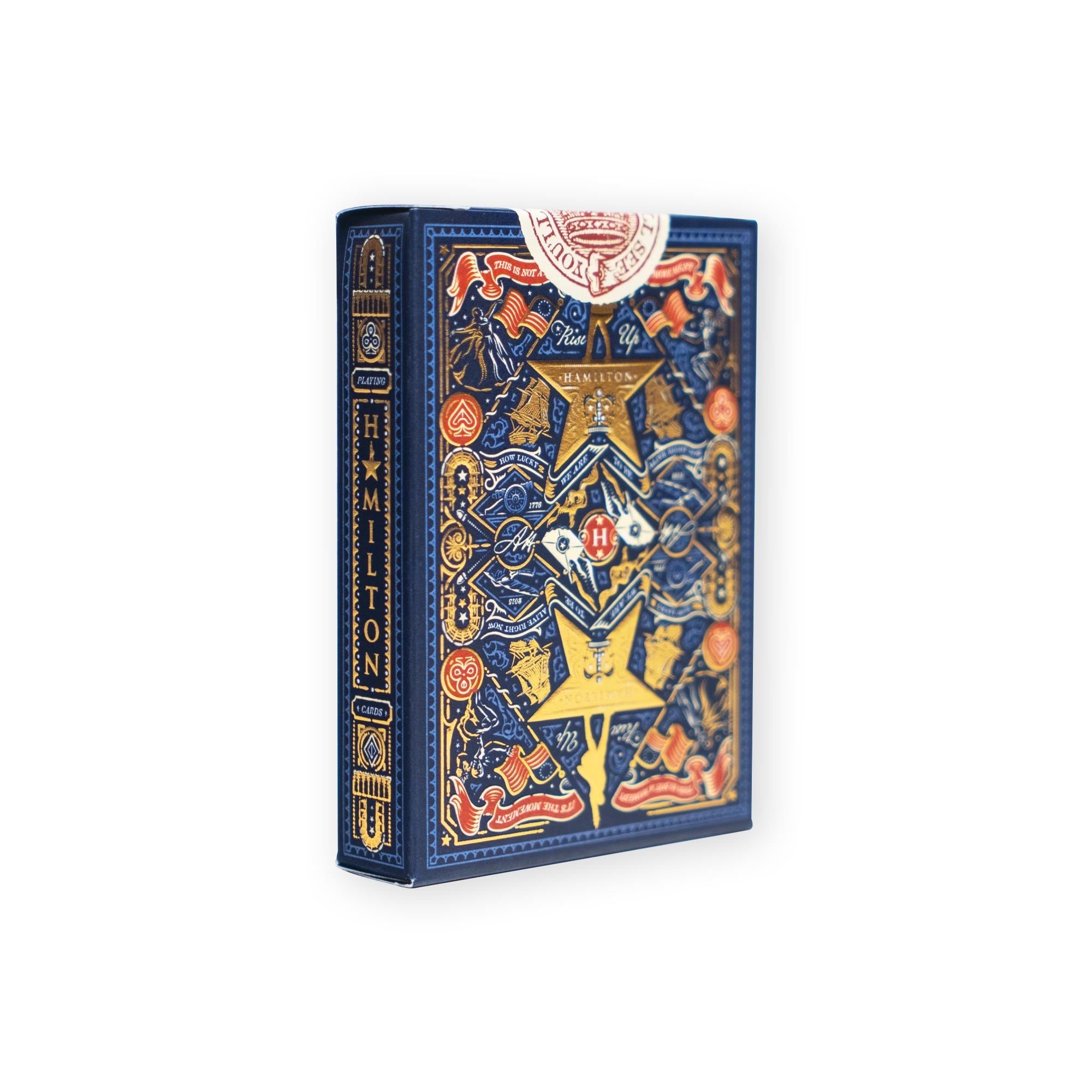 Introducing the Hamilton Playing Cards—a premium deck presented in a decorative blue and gold box, adorned with intricate patterns, star motifs, and the word "HAMILTON" on the spine. Inspired by the hit musical Hamilton, these collectible playing cards are an essential addition to any Broadway fan or collector’s merchandise collection.