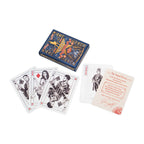 The Hamilton Playing Cards are displayed in an elegant decorative box alongside four face cards—Jack of Clubs, Queen of Diamonds, King of Spades, Ace of Hearts—and an informational card with red text, all arranged on a white surface. This premium set is inspired by the iconic Hamilton playing cards collection, making it a standout piece for Broadway musical fans and collectors.