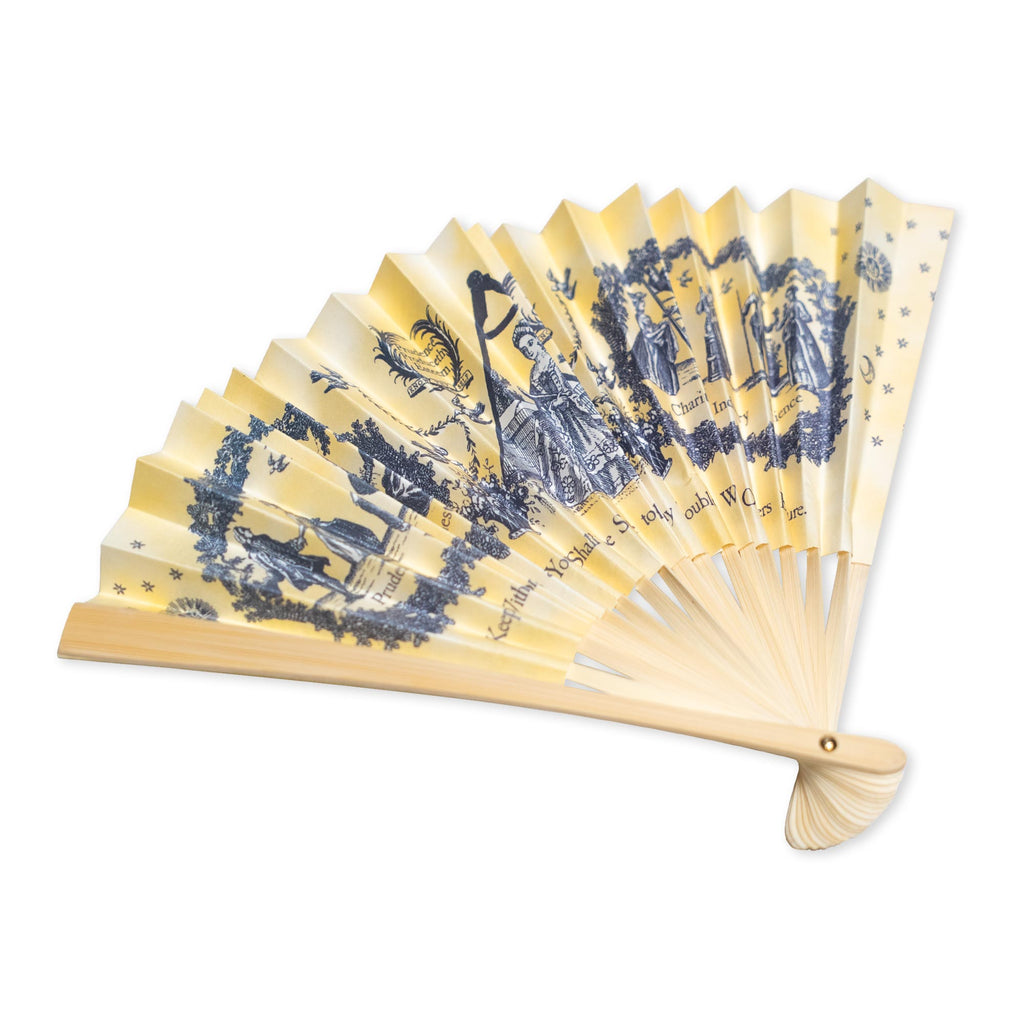 Introducing the Moral Compass Fan—a refined 18th-century decorative paper fan with cream-colored pleats, adorned with blue illustrations depicting historical figures and scenes alongside script, and finished with a light brown handle. This exquisite “Moral Compass Fan” beautifully embodies historical elegance, making it a timeless decorative accessory.
