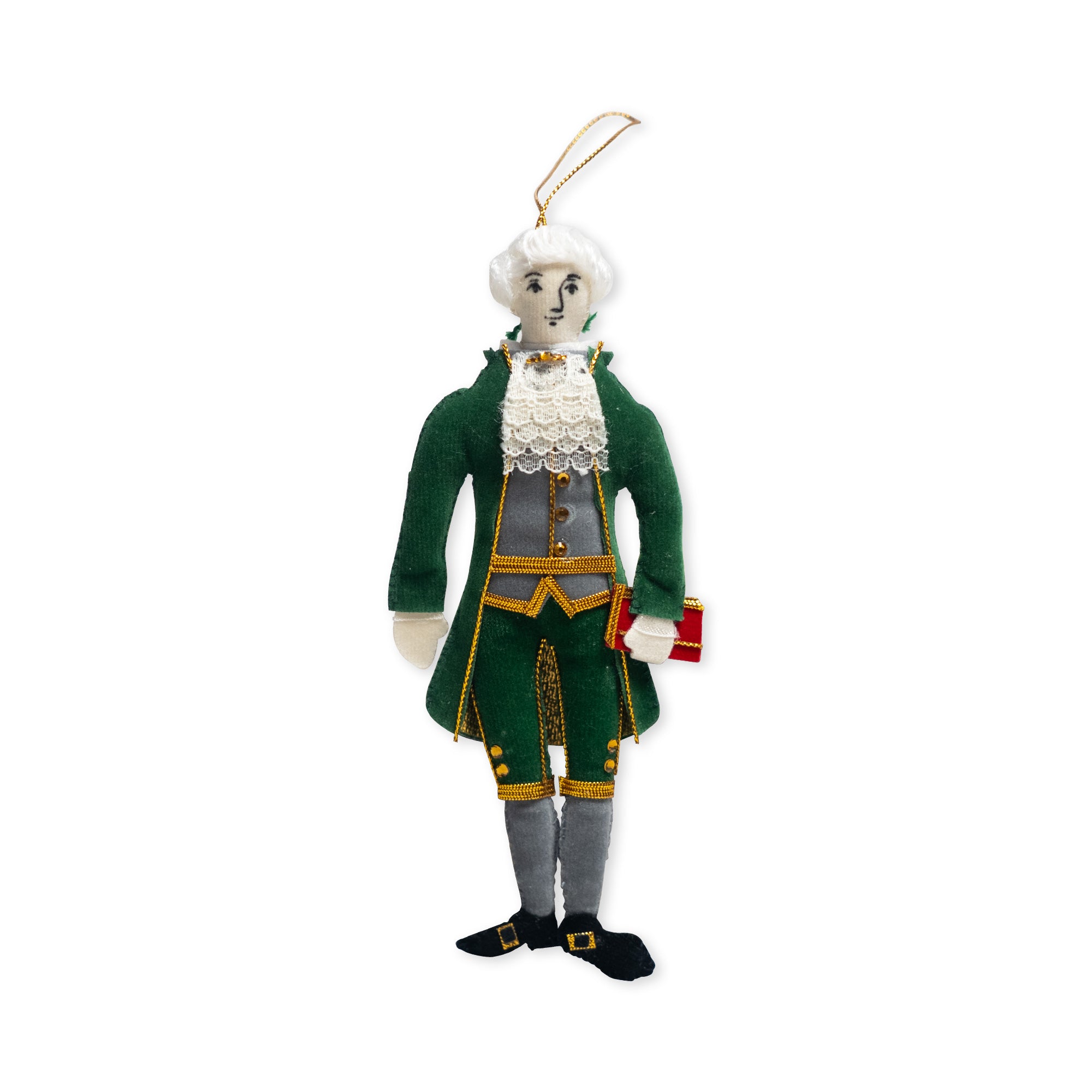 Celebrate American heritage with the Thomas Jefferson Ornament—a plush ornament featuring a figure in an elegant 18th-century green suit with gold trim, white lace collar, and white hair, holding a red book. Complete with a hanging loop on top, this charming keepsake is perfect for fans of the founding fathers.