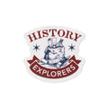 Introducing the History Explorers Sticker—a durable vinyl sticker showcasing the bold "History Explorers" text, vibrant stars, and an illustration of a bag stuffed with scrolls, a compass, and a magnifying glass. This sticker is ideal for American history enthusiasts and adventurers.