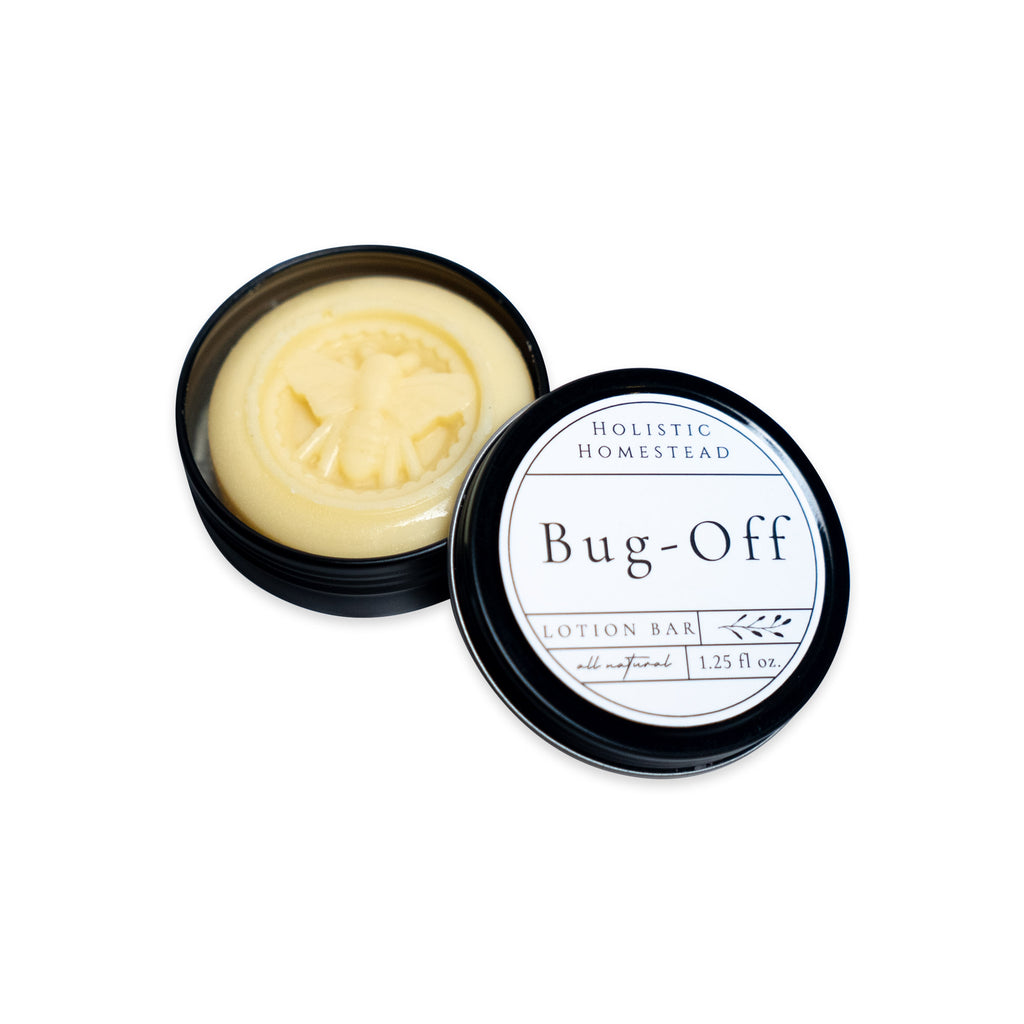 A round tin containing a Bug-Off Lotion Bar, Natural Bug Repellent embossed with a bee, with the lid lying beside it displaying the product name and information.