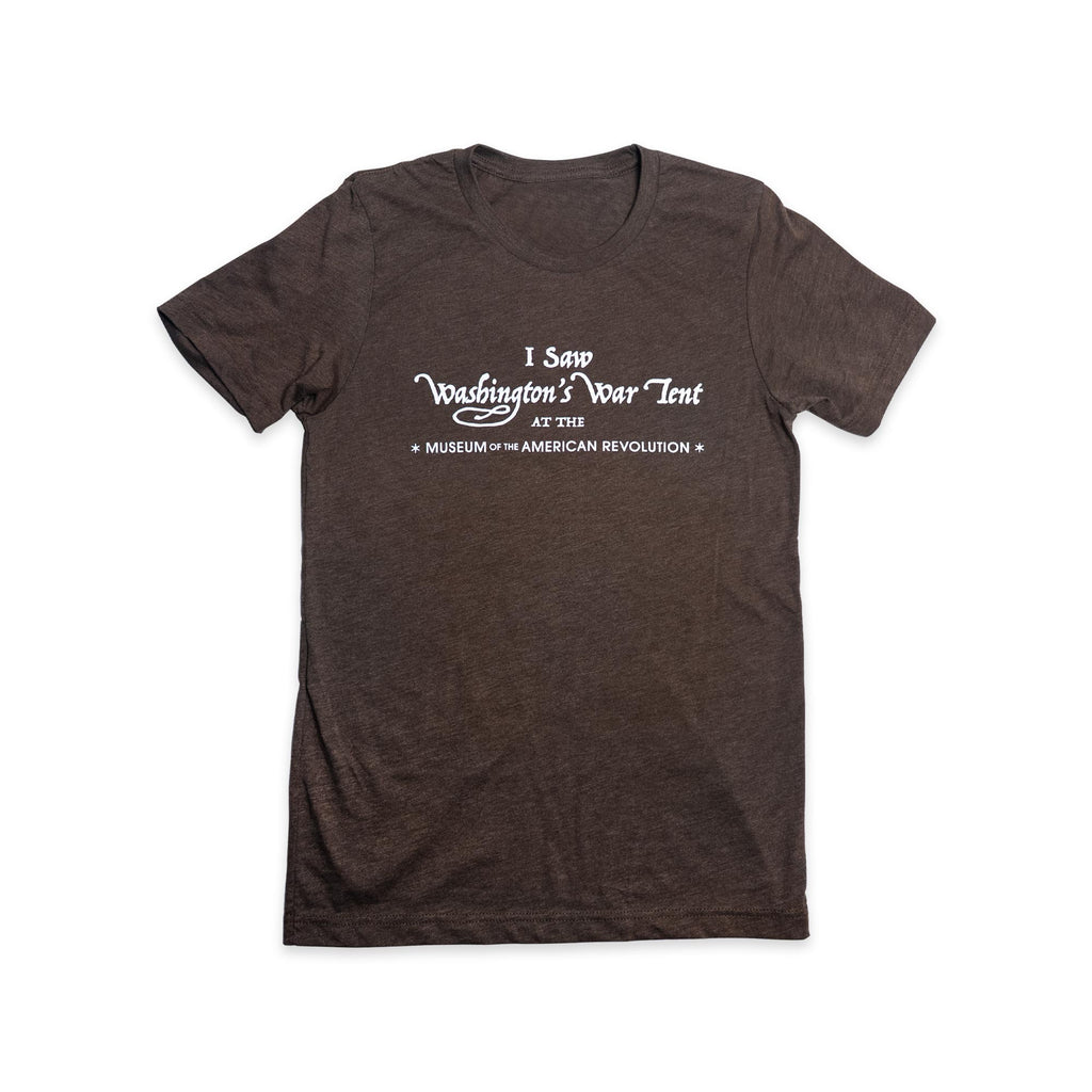 The “I Saw Washington’s War Tent” T-Shirt is brown with white text that reads, I Saw Washington’s War Tent at the Museum of the American Revolution, and is shown laid flat on a white background.