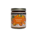 A glass jar of Pumpkin Butter with a label featuring illustrations of pumpkins.