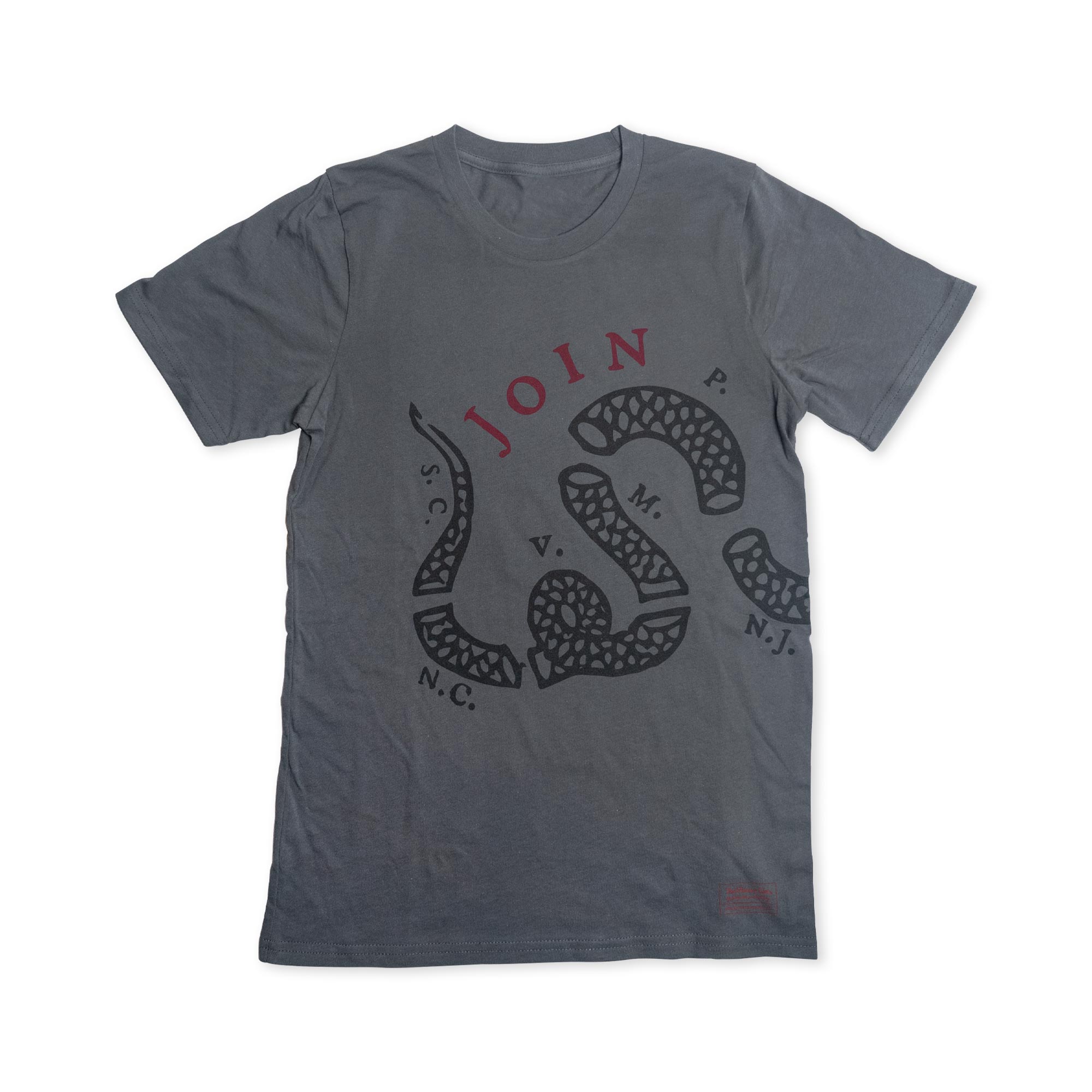 The Join or Die Crewneck T-Shirt features a gray base with a striking black segmented snake graphic and bold red “JOIN” text above it. Surrounding the snake are the letters P., N.C., S.C., V., and N.J., in reference to the historic “Join, or Die” image—a powerful symbol of Revolutionary-era political art—making this shirt an ideal choice for history enthusiasts and fans of American Revolution memorabilia.