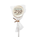 The Celebrating 250 Lollipop is a white, strawberry-flavored treat wrapped in clear plastic with a gold twist tie. Its label features “Museum of the American Revolution” at the top and reads “Celebrating 250 Years, 1776-2026,” making it a special commemorative candy for the 250th anniversary.