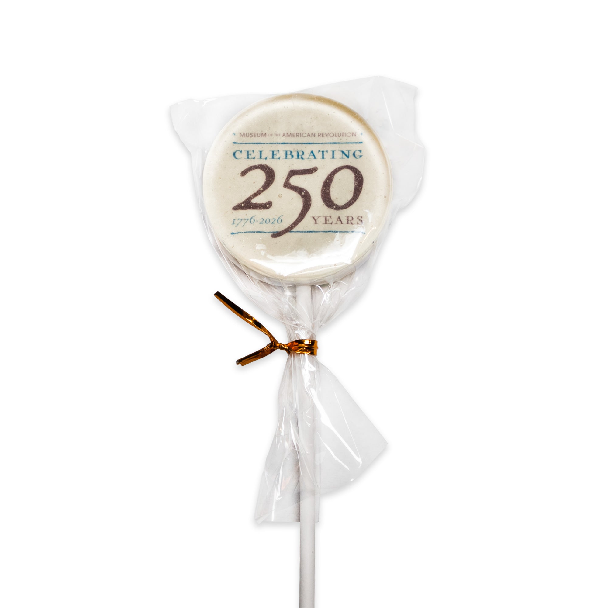 The Celebrating 250 Lollipop is a white, strawberry-flavored treat wrapped in clear plastic with a gold twist tie. Its label features “Museum of the American Revolution” at the top and reads “Celebrating 250 Years, 1776-2026,” making it a special commemorative candy for the 250th anniversary.