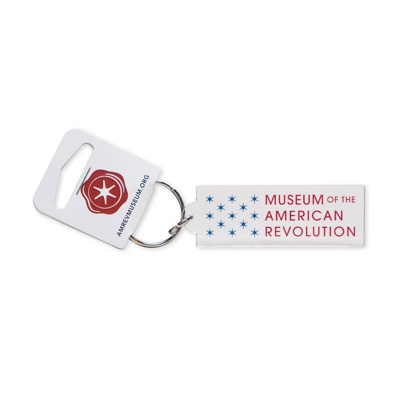 The Acrylic Museum Keychain is a rectangular acrylic accessory featuring the Museum of the American Revolution and blue stars, attached to a white tag with a red emblem and the website amrevmuseum.org—making it an ideal collectible gift for history enthusiasts.