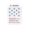 Rectangular, weather-resistant Museum Logo Vinyl Sticker featuring thirteen blue stars and the words “Museum of the American Revolution” in bold blue and red text. A top tab reads: “Vinyl Sticker. Made in USA. MORSBOTS.COM.” This sticker is perfect for history enthusiasts looking to show off their passion for American history.