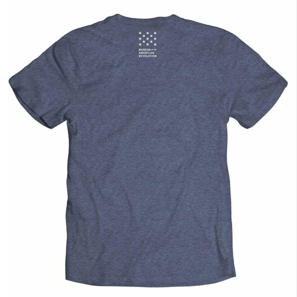 The Witness to Revolution T-shirt in heather blue is shown from the back, with a small white design near the neckline featuring semicircular stars above "Museum of the American Revolution." 