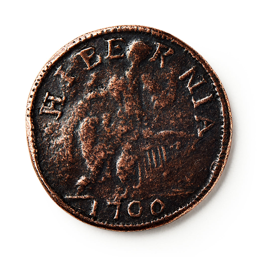 A worn 1760 Voce Populi Halfpenny features HIBERNIA at the top, with a faint central figure. Though wear obscures details, this colonial-era copper coin remains a prized historic collectible.