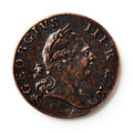 A close-up of a 1773 Virginia Halfpenny, an old British colonial coin showing a right-facing man with a laurel crown. The edge reads GEORGIUS III. REX, with COPY marked at the bottom of this historic currency.