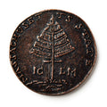 The 1776 Pine Tree Copper Coin features a detailed pine tree at its center, with MASSACHUSETTS and STATE inscribed along the edge—an iconic piece of early American currency representing colonial independence.