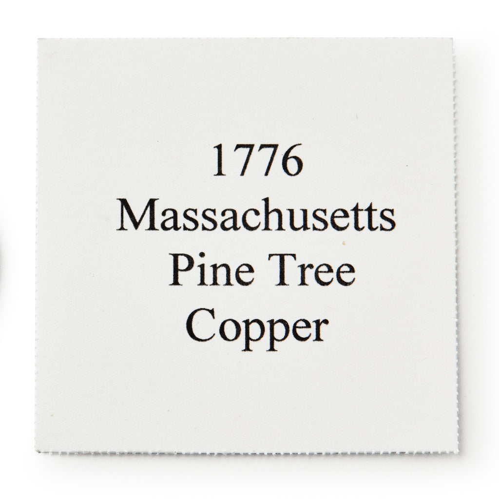 A white square paper with black text that reads: 1776 Pine Tree Copper Coin, a symbol of colonial independence and early American currency.