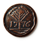The 1776 New Hampshire Halfpenny features a raised tree design above the year 1776, reflecting early American independence, set against a crisp white background.