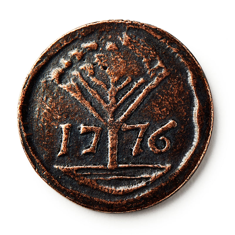The 1776 New Hampshire Halfpenny features a raised tree design above the year 1776, reflecting early American independence, set against a crisp white background.