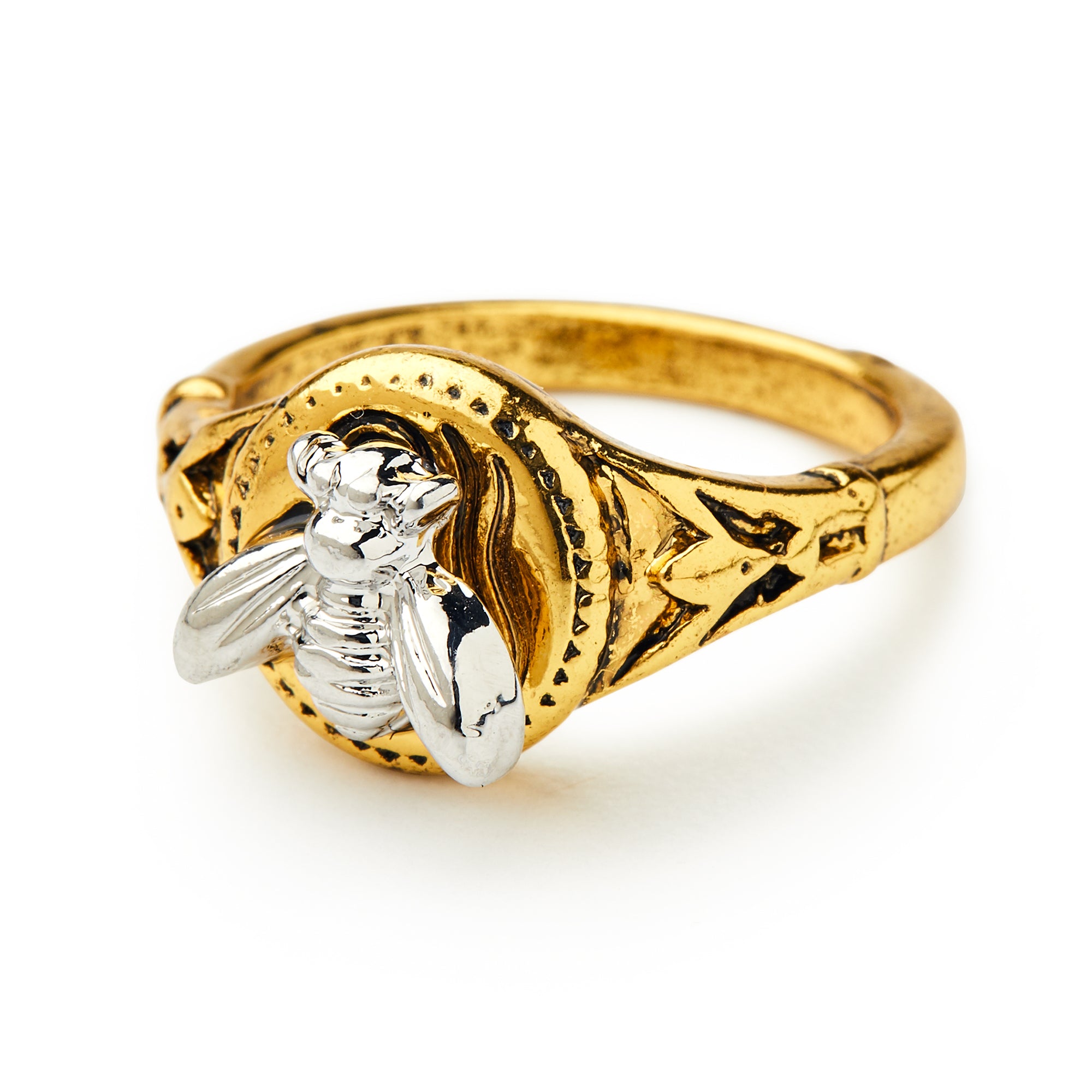 The Bee Ring showcases a gold-plated band with engraved accents and a raised silver-plated bee on its circular centerpiece, all displayed on a white background—offering unique style.