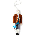 The Benjamin Franklin Ornament features his iconic white hair, glasses, brown coat, blue vest, and gray pants while holding a blue kite with a string.