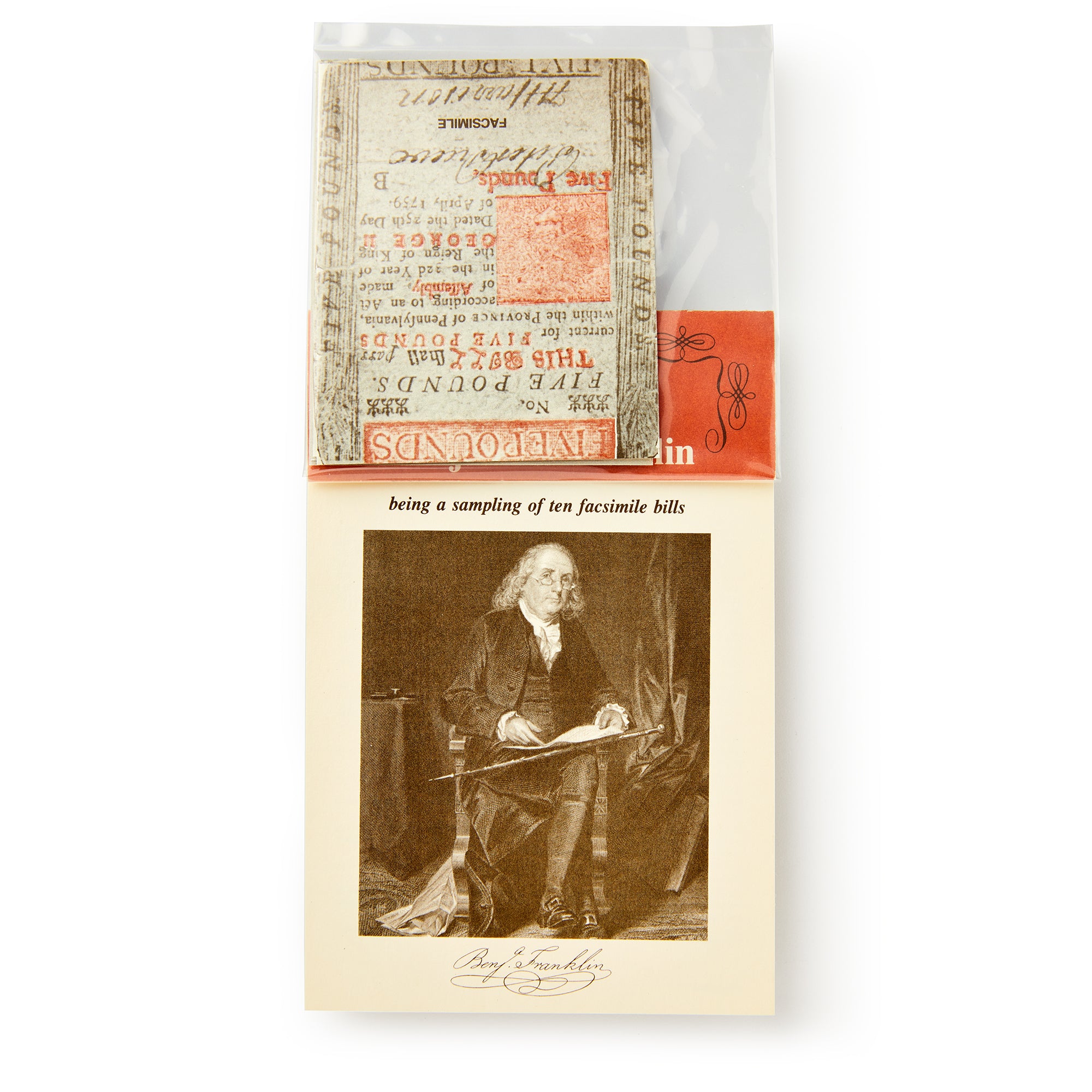 A packet of Benjamin Franklin Paper Money is partially visible above a card showing an old-fashioned illustration of Franklin seated and writing, with his signature printed beneath the image.