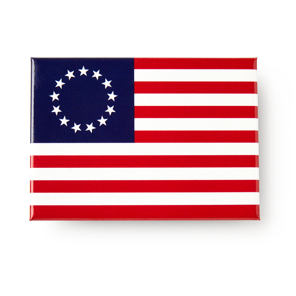 The Betsy Ross Flag Magnet features thirteen red and white stripes and a blue field with a circle of thirteen white stars.
