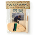 The Boat Kit includes a precut wood hull, a sail to sew, and an instruction booklet featuring a child by the water. Labeled "You Can Learn... Basic skills from Early American Life.