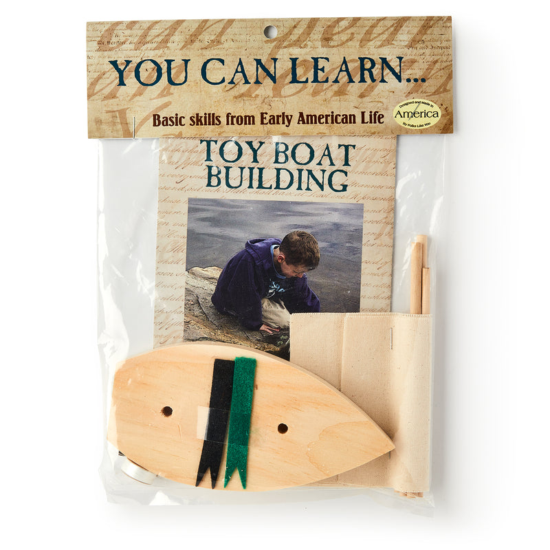 The Boat Kit includes a precut wood hull, a sail to sew, and an instruction booklet featuring a child by the water. Labeled "You Can Learn... Basic skills from Early American Life.
