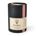 A vintage-style black cylindrical container labeled "Breakfast Loose Leaf Tea," 4 oz net weight, with a red striped ribbon—ideal for fans of strong black tea blends.
