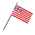 The Grand Union Stick Flag features thirteen red and white stripes with the British Union Jack in the upper left corner, mounted on a black pole topped with a gold spear tip.