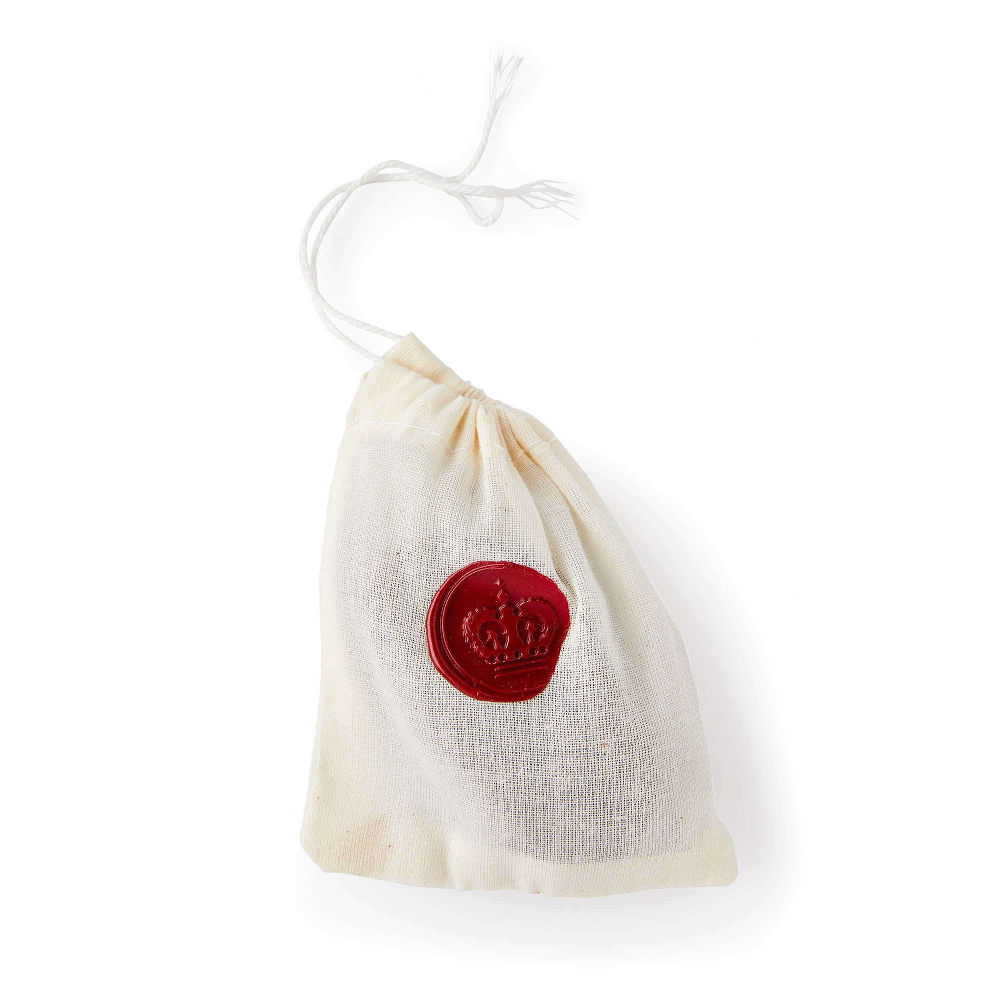 A small white drawstring cloth bag with a red crown patch in the center holding Chocolate Shillings is displayed on a white background.