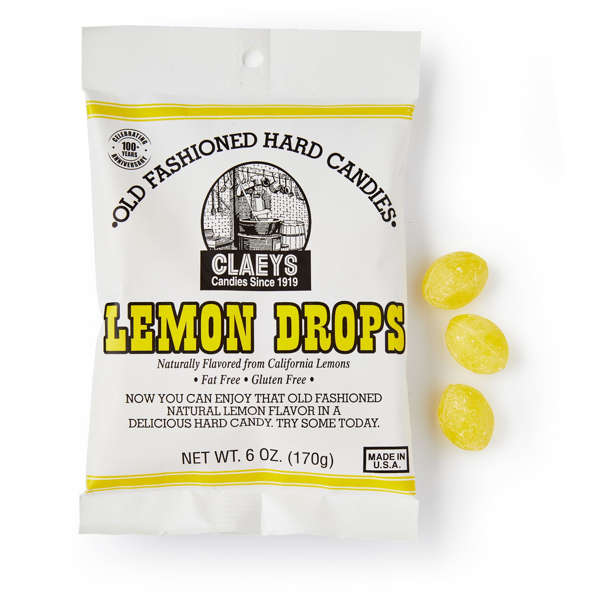 A white bag of Lemon Old Fashioned Hard Candies, labeled "Old Fashioned Hard Candies" with yellow accents, is shown beside three yellow lemon drops. Net weight: 6 oz (170g).